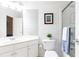 Bright bathroom with a white vanity, framed mirror, modern fixtures, shiplap walls, and glass enclosed shower at 825 Glengate Pl, Atlanta, GA 30328