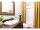 Stylish bathroom featuring a decorative mirror, wooden vanity, and tiled shower at 825 Glengate Pl, Atlanta, GA 30328