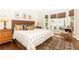 Comfortable bedroom with a bay window, hardwood floors, and decorative rug at 825 Glengate Pl, Atlanta, GA 30328