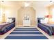 Spacious, well-lit bedroom, featuring two beds, a ceiling fan, and a symmetrical design for a cozy and inviting feel at 825 Glengate Pl, Atlanta, GA 30328