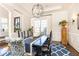 Elegant dining room with a chandelier, a long table, patterned chairs, and a large window at 825 Glengate Pl, Atlanta, GA 30328