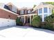 Beautiful brick home with a well-manicured lawn, a gabled roof, and a charming front entrance at 825 Glengate Pl, Atlanta, GA 30328