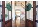 Inviting foyer with gleaming hardwood floors and staircase visible through double front doors at 825 Glengate Pl, Atlanta, GA 30328