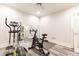 Home gym equipped with workout machines, a mirror, and modern flooring for fitness activities at 825 Glengate Pl, Atlanta, GA 30328