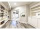 Hallway featuring custom bookshelves and cabinetry, with access to a sunroom, creating a cozy and functional space at 825 Glengate Pl, Atlanta, GA 30328