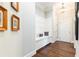 Inviting hallway with a built-in bench and coat hooks, complemented by hardwood flooring at 825 Glengate Pl, Atlanta, GA 30328