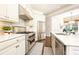 Modern kitchen featuring stainless steel appliances, white cabinetry, and white countertops at 825 Glengate Pl, Atlanta, GA 30328