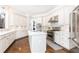 A beautifully updated kitchen with white cabinets, stainless steel appliances, and hardwood flooring at 825 Glengate Pl, Atlanta, GA 30328