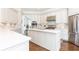 Spacious white kitchen with stainless steel appliances, an island, and hardwood floors at 825 Glengate Pl, Atlanta, GA 30328
