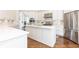 Elegant kitchen with a large island, stainless steel appliances, and white cabinetry at 825 Glengate Pl, Atlanta, GA 30328