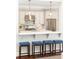 Modern kitchen features a breakfast bar with stool seating, stainless steel appliances and pendant lighting at 825 Glengate Pl, Atlanta, GA 30328