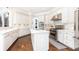 Bright, updated kitchen with island, stainless appliances, and pristine white cabinets at 825 Glengate Pl, Atlanta, GA 30328