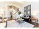 Cozy living room with hardwood floors, a plush sofa, stylish decor, and staircase at 825 Glengate Pl, Atlanta, GA 30328