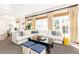 Comfortable living space featuring a large sectional sofa, expansive windows, and hardwood flooring accents at 825 Glengate Pl, Atlanta, GA 30328