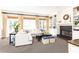 Bright living room with fireplace, built-in shelving, and large windows dressed with neutral curtains and woven shades at 825 Glengate Pl, Atlanta, GA 30328