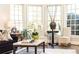 Bright living room with large windows, hardwood floors, comfortable seating, and stylish decor at 825 Glengate Pl, Atlanta, GA 30328
