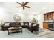 Bright living room with a brown sectional sofa, decorative pillows, and a beverage bar at 825 Glengate Pl, Atlanta, GA 30328