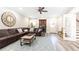 Comfortable living room with a large brown sectional sofa, a ceiling fan, and a built-in bar area at 825 Glengate Pl, Atlanta, GA 30328