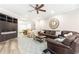Spacious living room featuring a brown sectional sofa, TV, and a pool table for entertainment at 825 Glengate Pl, Atlanta, GA 30328