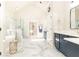 Luxury bathroom features marble floor, soaker tub, glass shower and blue vanity at 825 Glengate Pl, Atlanta, GA 30328