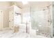 A luxury bathroom featuring a soaking tub, glass shower, skylight and marble tile at 825 Glengate Pl, Atlanta, GA 30328