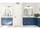 Bathroom with dual sinks, large mirrors, blue cabinets and marble floor at 825 Glengate Pl, Atlanta, GA 30328