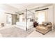 Spacious bedroom with sitting area, four poster bed and ensuite bath with sliding barn door at 825 Glengate Pl, Atlanta, GA 30328