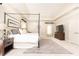 Large bedroom with four poster bed, gray rug, trey ceiling and neutral color palette at 825 Glengate Pl, Atlanta, GA 30328