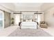Spacious bedroom with a four poster bed, sitting area and ensuite bath with sliding barn door at 825 Glengate Pl, Atlanta, GA 30328