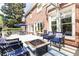 Inviting patio with a fire pit, comfortable seating, and brick exterior, perfect for outdoor gatherings at 825 Glengate Pl, Atlanta, GA 30328