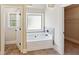 Bright bathroom featuring a soaking tub, tile floors, and convenient access to a walk-in closet at 1301 Odell Ct, Hoschton, GA 30548