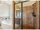 Stylish bathroom featuring a glass-enclosed shower and a separate soaking tub at 1301 Odell Ct, Hoschton, GA 30548