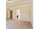 Spacious bedroom featuring neutral carpet, trim and multiple doorways that enhance the room's openness at 1301 Odell Ct, Hoschton, GA 30548