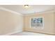 Well-lit bedroom boasts a large window offering pleasant views of the outdoors at 1301 Odell Ct, Hoschton, GA 30548