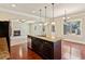 Open-concept kitchen with a large island, stainless steel appliances, and views of a fireplace at 1301 Odell Ct, Hoschton, GA 30548