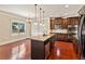 Boasts an island, stainless steel dishwasher, and hardwood floors for a modern aesthetic at 1301 Odell Ct, Hoschton, GA 30548