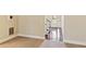 Cozy living room featuring carpeted floors and an entry leading to the home's main staircase at 1301 Odell Ct, Hoschton, GA 30548