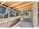 Enclosed sunroom offers a serene space with views of the lush, private backyard at 1301 Odell Ct, Hoschton, GA 30548