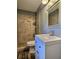 Modern bathroom features stylish tile shower, vanity, and fixtures at 1320 Milstead Ne Ave, Conyers, GA 30012