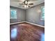 Well lit bedroom features neutral walls and wood floors at 1320 Milstead Ne Ave, Conyers, GA 30012