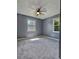 Well lit bedroom features neutral walls and carpet at 1320 Milstead Ne Ave, Conyers, GA 30012