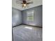 Serene bedroom with plush carpet, natural light, and soothing grey walls for restful nights at 1320 Milstead Ne Ave, Conyers, GA 30012