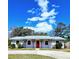 Charming single-story home with a well-maintained yard, metal roof, and a bright red front door at 1320 Milstead Ne Ave, Conyers, GA 30012
