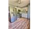 Functional kitchen with stainless steel appliances, white cabinets, and durable hardwood floors at 1320 Milstead Ne Ave, Conyers, GA 30012