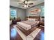 Comfortable main bedroom features wood accents, wood floors, and large windows at 1320 Milstead Ne Ave, Conyers, GA 30012