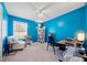 Bright blue room features a window with a view, a ceiling fan, and carpet at 181 Bridgewood Se Dr, Conyers, GA 30094