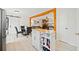 Bright eat-in kitchen featuring wood floors and a portable island, perfect for meal preparation and dining at 181 Bridgewood Se Dr, Conyers, GA 30094