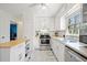 Well-lit kitchen featuring stainless steel appliances, an island, and an undermount sink at 181 Bridgewood Se Dr, Conyers, GA 30094