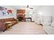 Refinished floors extend throughout the light and open living room, with a fireplace and stylish furniture at 181 Bridgewood Se Dr, Conyers, GA 30094