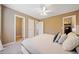 Comfortable main bedroom features neutral paint, a ceiling fan, and access to a walk-in closet at 181 Bridgewood Se Dr, Conyers, GA 30094